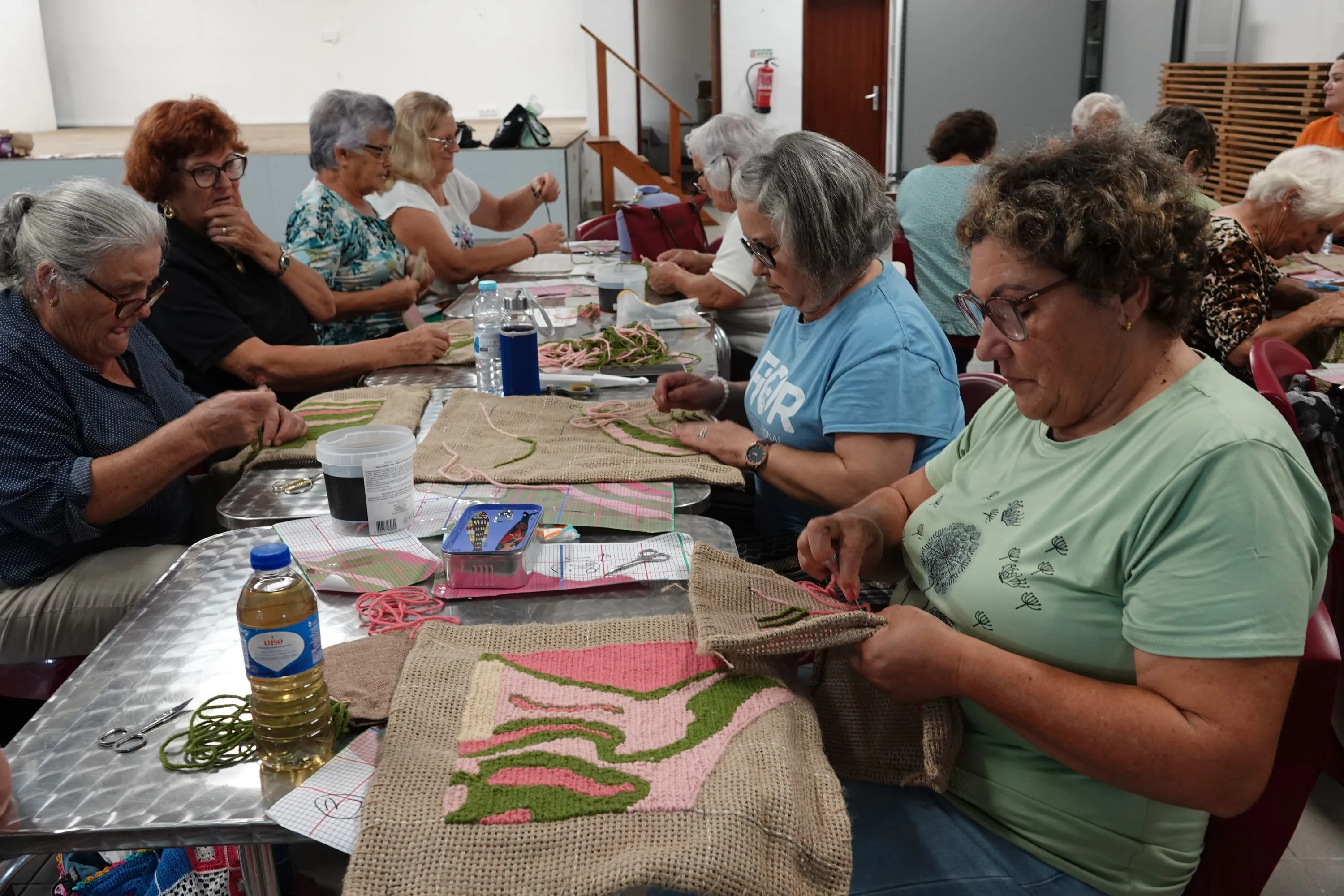 Participants embroidering textile modules during the PONTO E TRAMA co-creative residency.