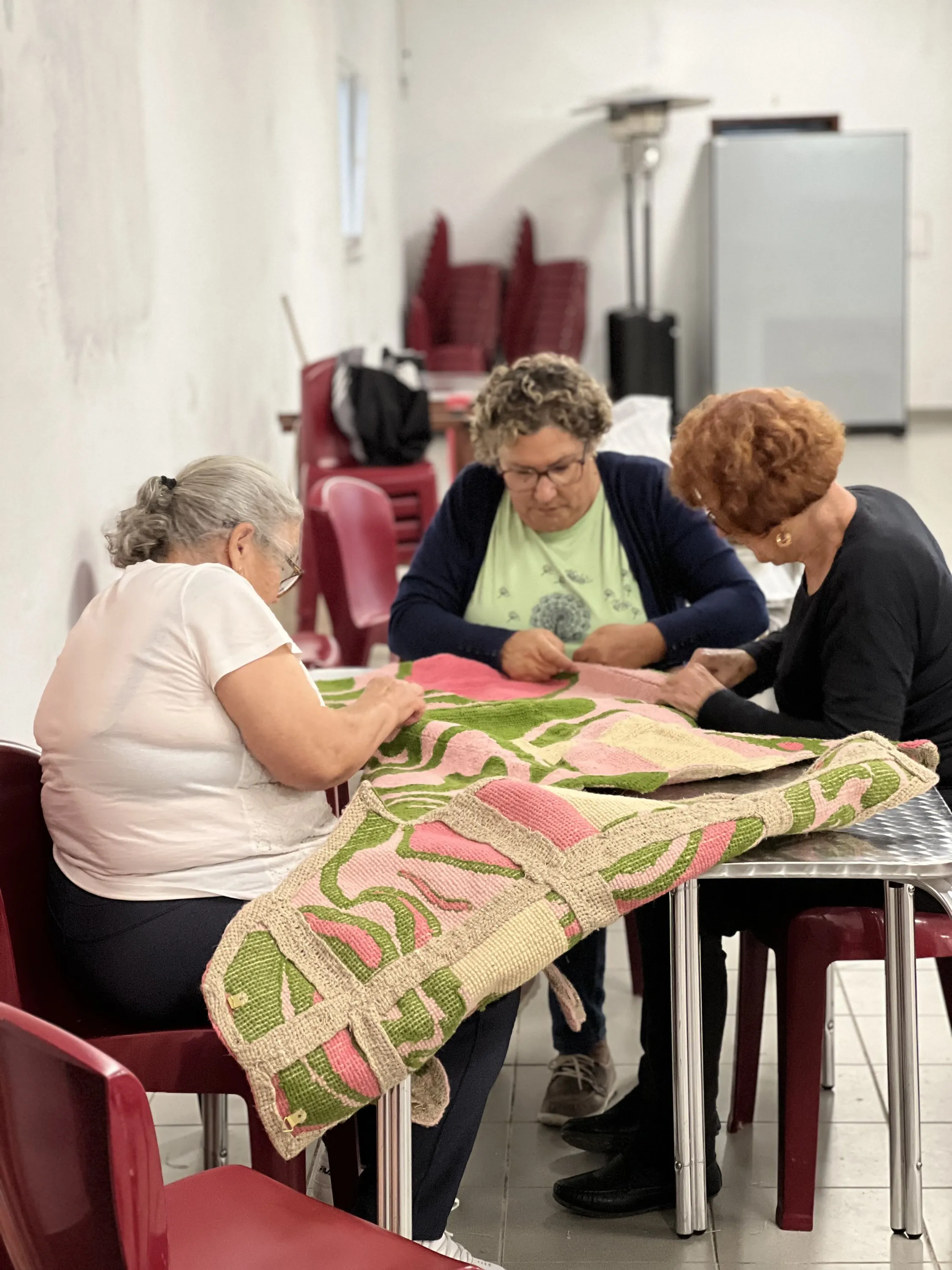 Participants working together on a larger assembled textile panel near the end of the residency.